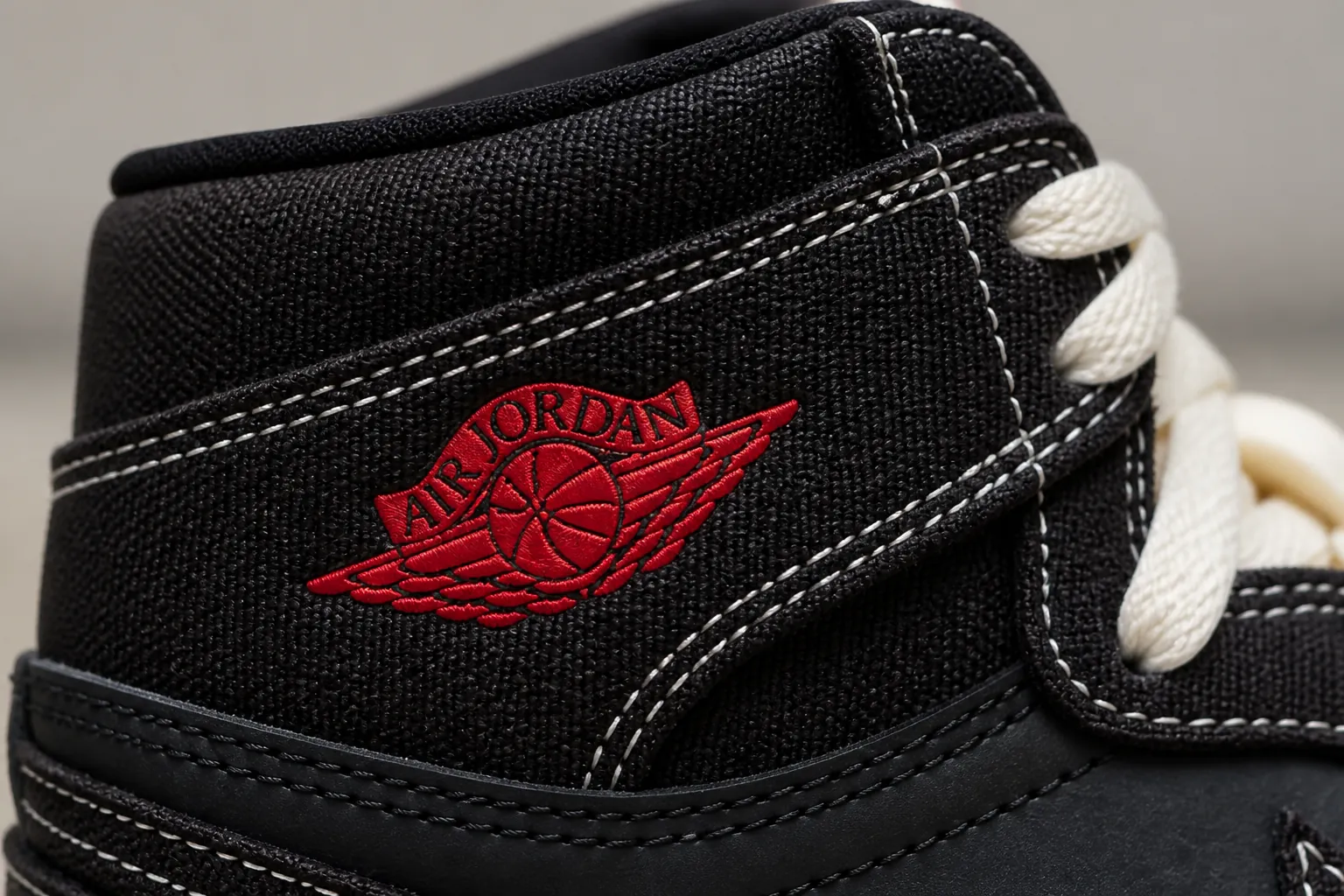 Detailed macro shot of the premium black woven textile upper showcasing intricate weaving patterns and texture quality