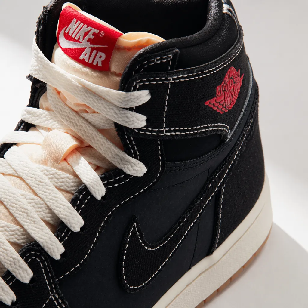 Modern Air Jordan 1 High OG Flight Club displayed on clean white background with dramatic lighting highlighting the woven textile upper and University Red accents