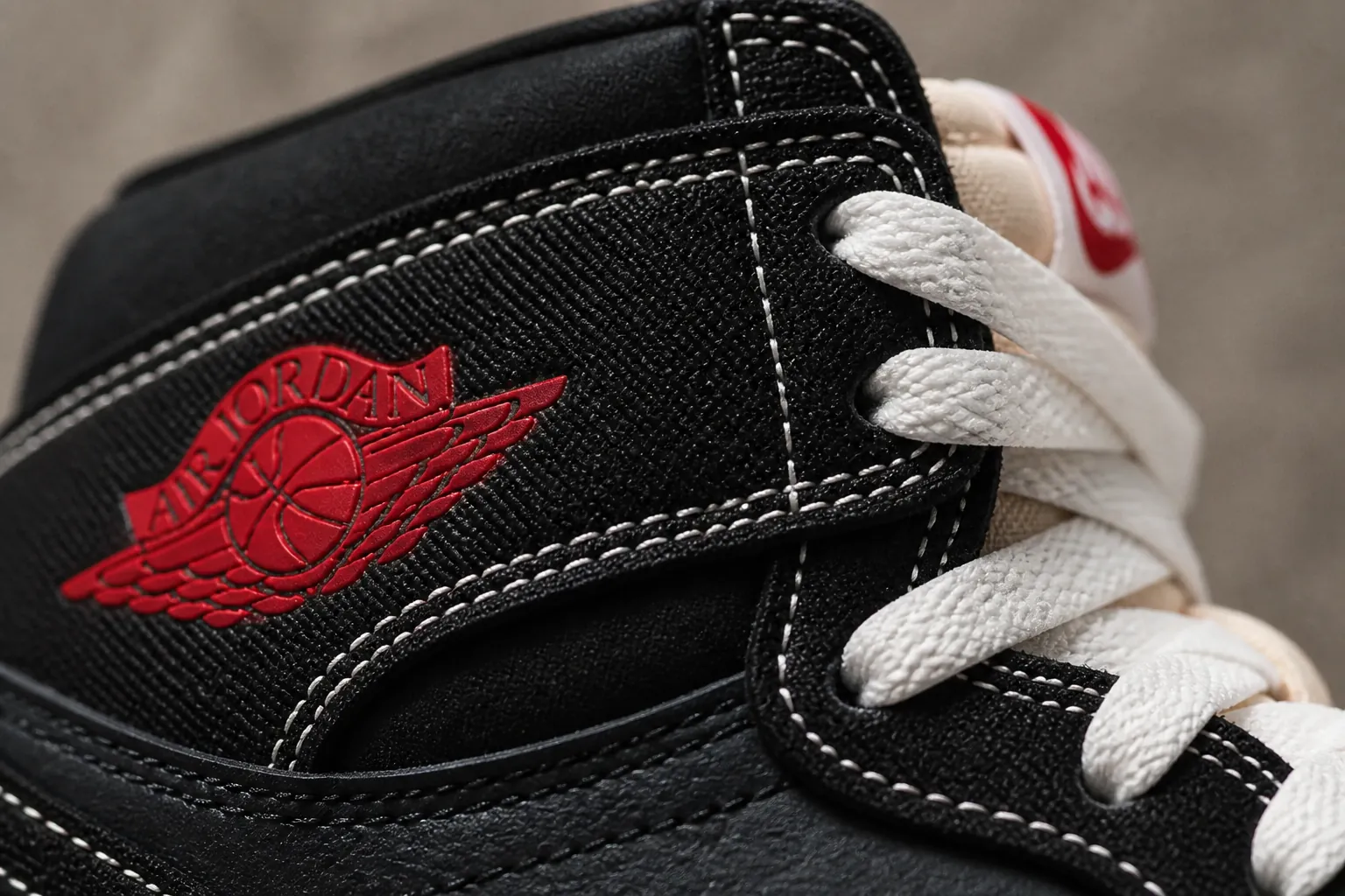 Close-up macro shot of premium black woven textile upper showing intricate cross-hatch pattern and texture