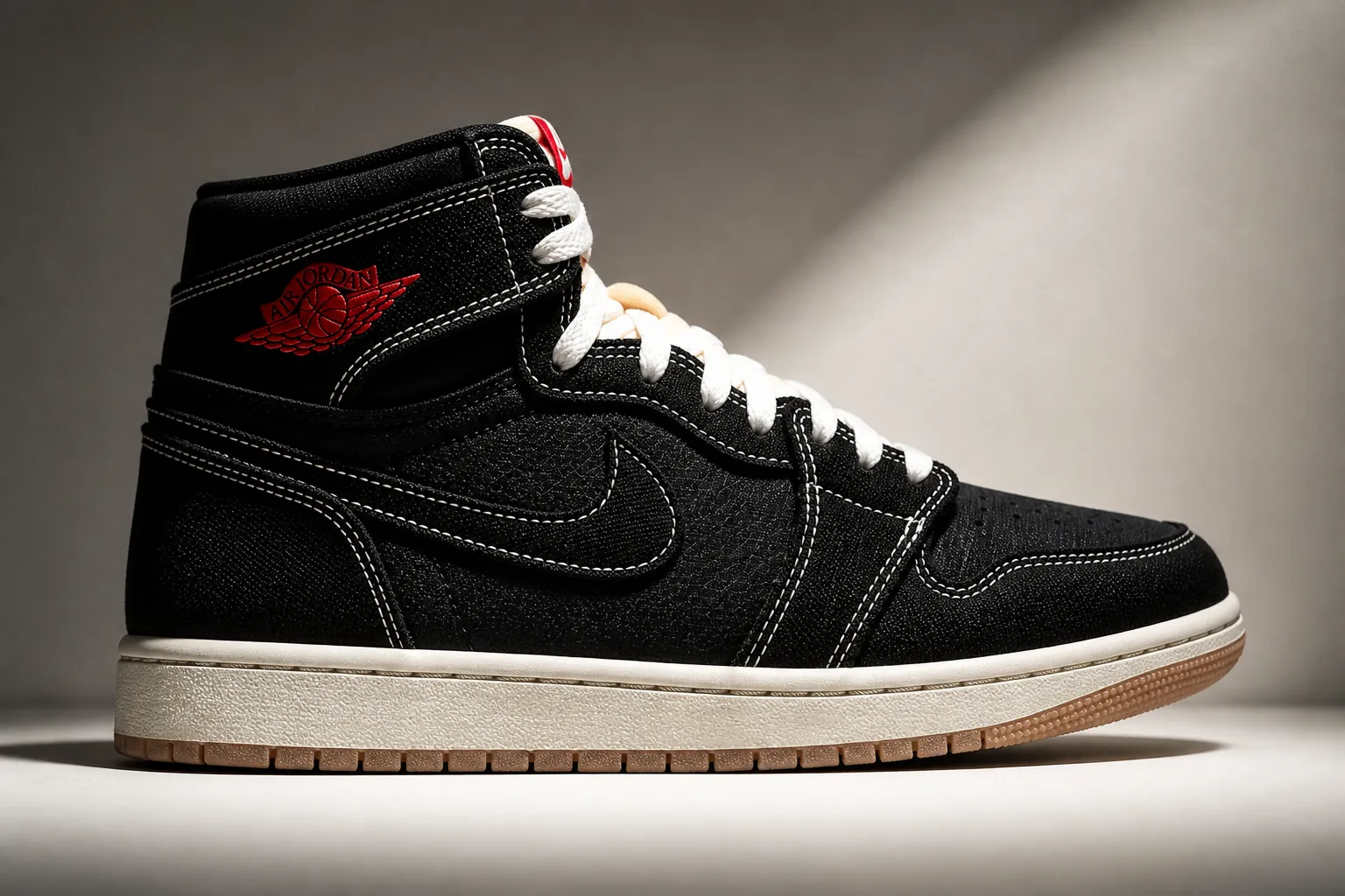 Close-up of the iconic Jumpman logo embroidered on premium woven textile with intricate stitching details highlighted by dramatic spotlight