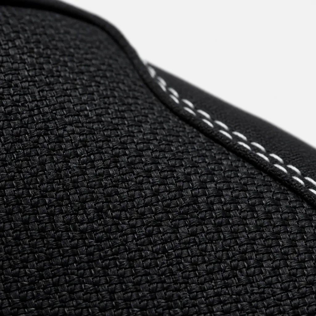 Macro close-up of woven textile upper showing detailed crosshatch weave pattern with black and charcoal threads