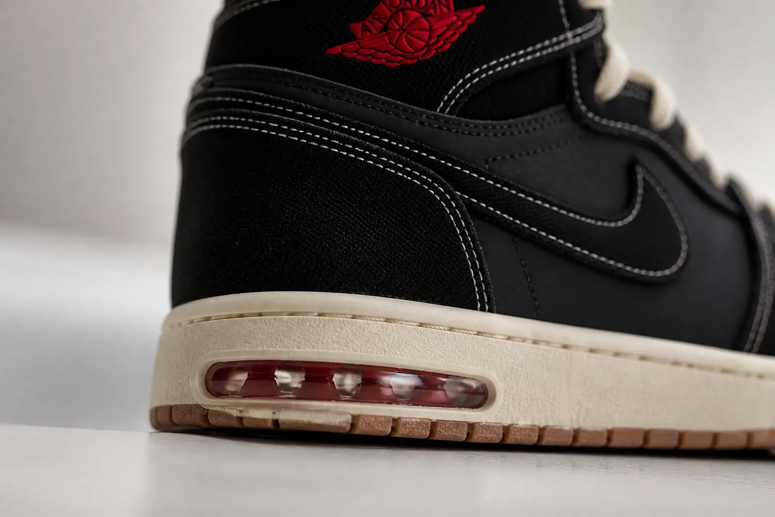 Detailed view of the encapsulated Nike Air-Sole unit in the heel showing the visible air bubble through the translucent midsole with red accent