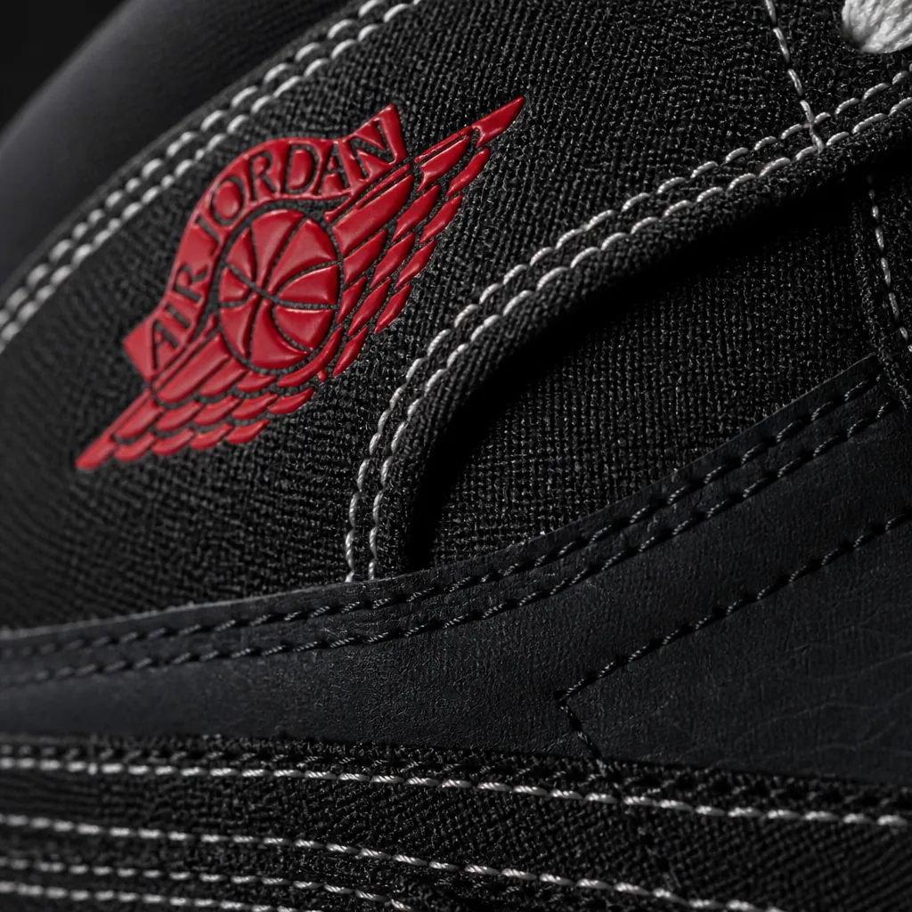 Extreme close-up photograph of the Air Jordan 1 Flight Club black woven textile upper texture, showcasing the intricate weaving pattern and premium material quality