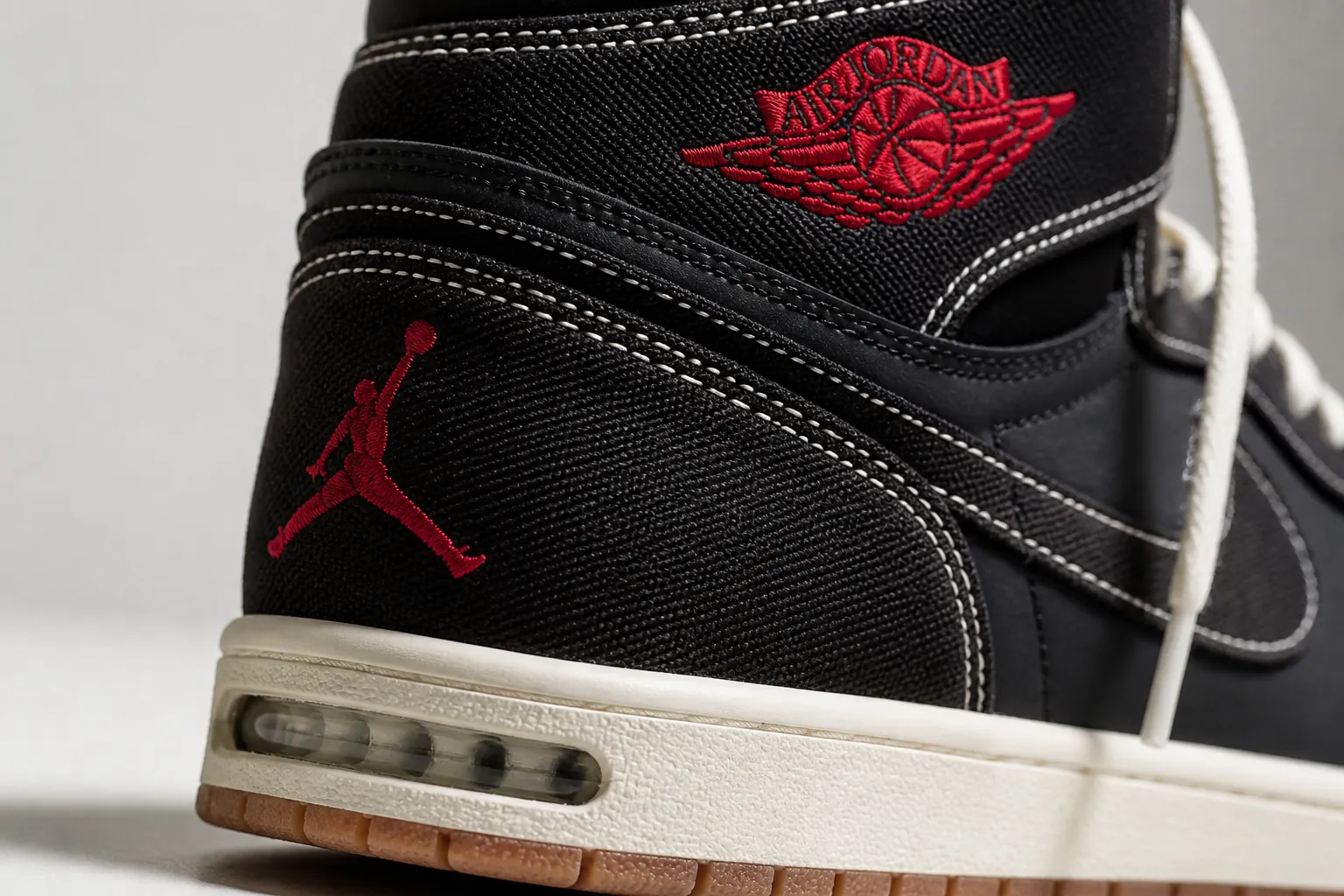 Close-up macro shot of the heel area showing the encapsulated Nike Air-Sole unit technology and detailed Jumpman logo embroidery with precision stitching