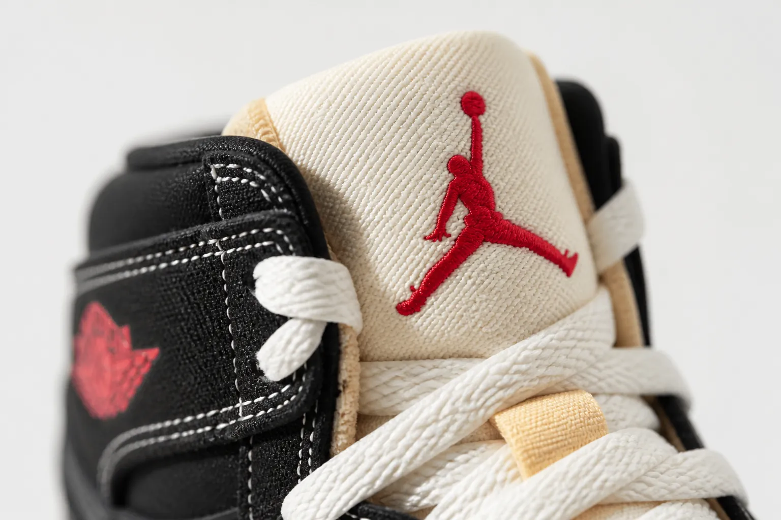 Detailed view of the Jumpman logo embroidered on the shoe tongue showing precise stitching and red thread accents with perfect placement