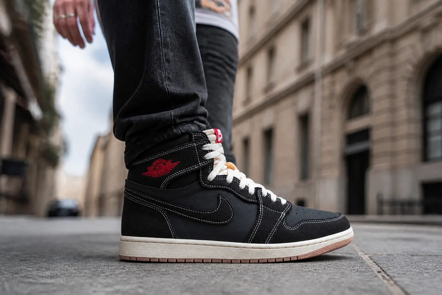 Sneaker enthusiast wearing Air Jordan 1 Flight Club in urban street setting showing confident styling with dark denim and graphic tee