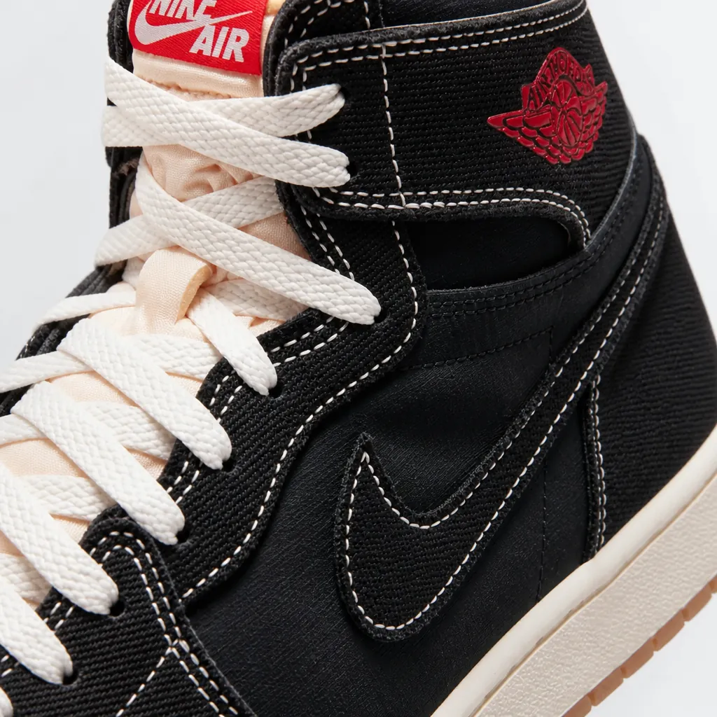 Close-up detail shot of black woven textile upper showing premium material texture and craftsmanship