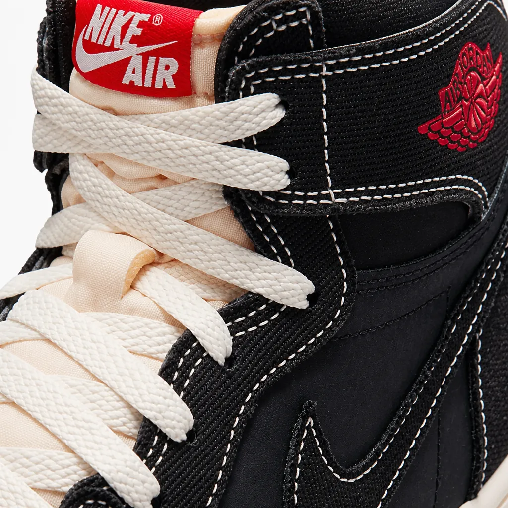 Close-up detail shot of the premium black woven textile upper texture of Air Jordan 1 Flight Club showcasing intricate weaving pattern and material quality