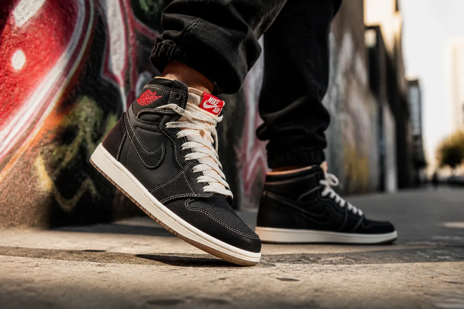 Urban lifestyle photograph showing someone confidently wearing Air Jordan 1 Flight Club sneakers walking through a city street with dramatic lighting and street art backdrop