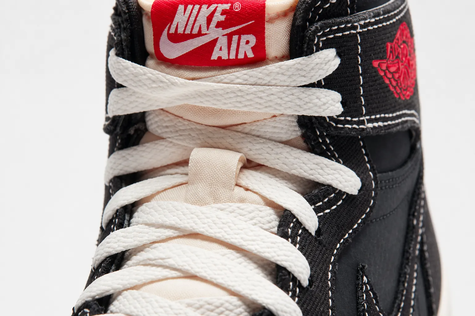Close-up detail of black woven textile upper on Air Jordan 1 Flight Club showing premium material quality and texture
